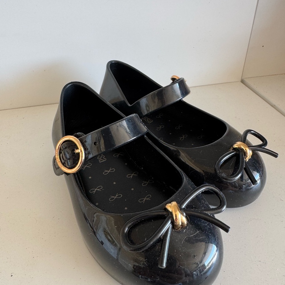Mini Melissa Black Dress Shoes with Gold Bow